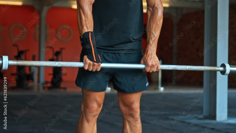 European athlete lifting weights, with the support of a wrist brace for