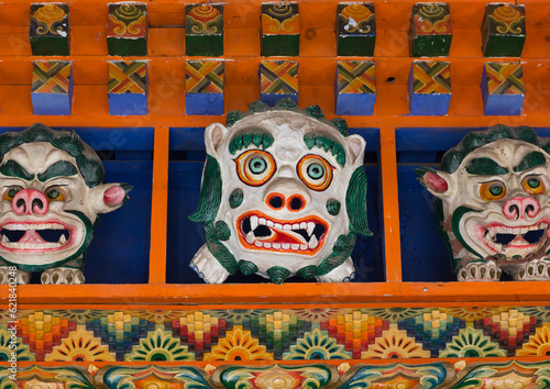 Monsters statues above the entrance of the temple in Bongya monastery, Qinghai province, Mosele, China photo