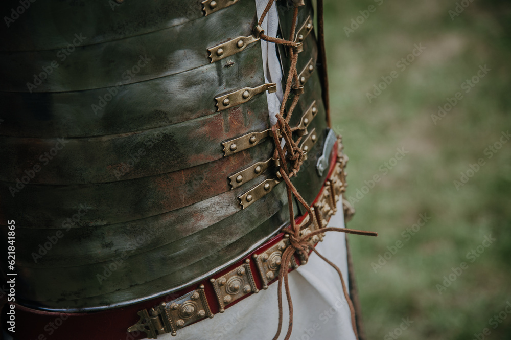 An up-close view of a Roman armor showcasing steel plates and leather joints, displaying the meticulous craftsmanship of ancient Roman warfare. An up-close view of a Roman armor showcasing steel plates and leather joints, displaying the meticulous craftsmanship of ancient Roman warfare.