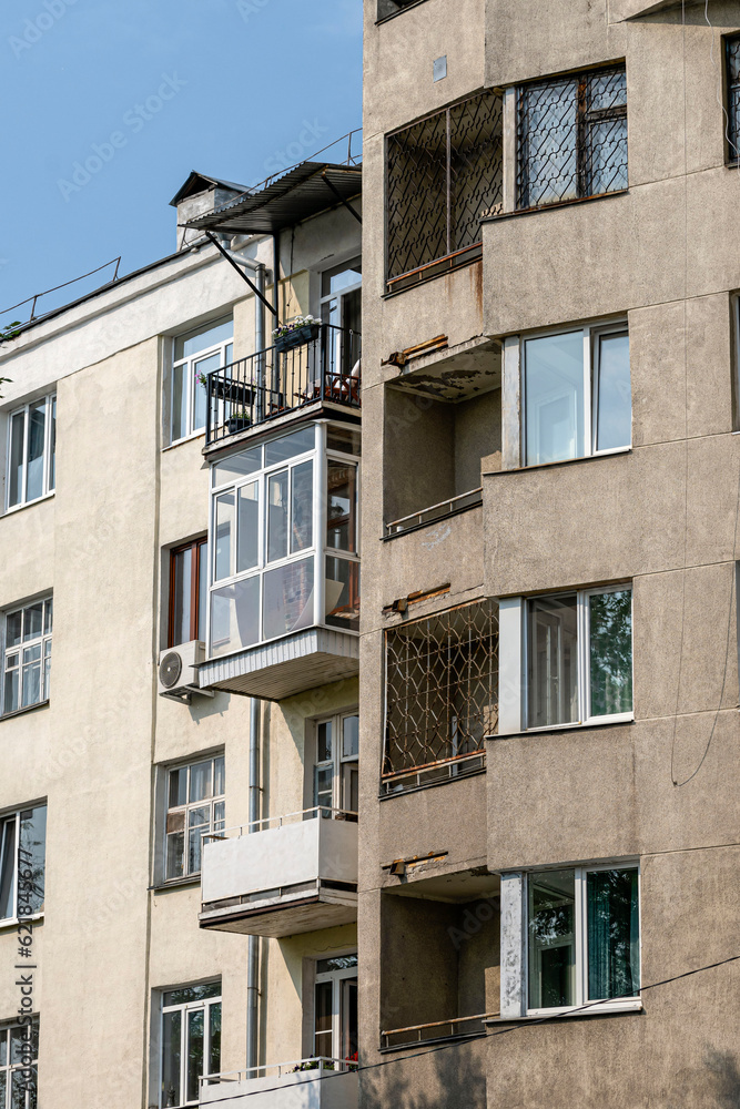 Fragment of the facade of a multi-storey residential building on a summer day