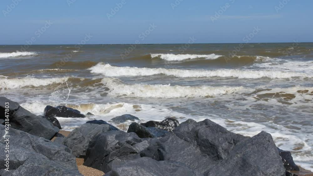Waves rollin in from the sea crashing on to rocks Waves rollin in from the sea crashing on to rocks