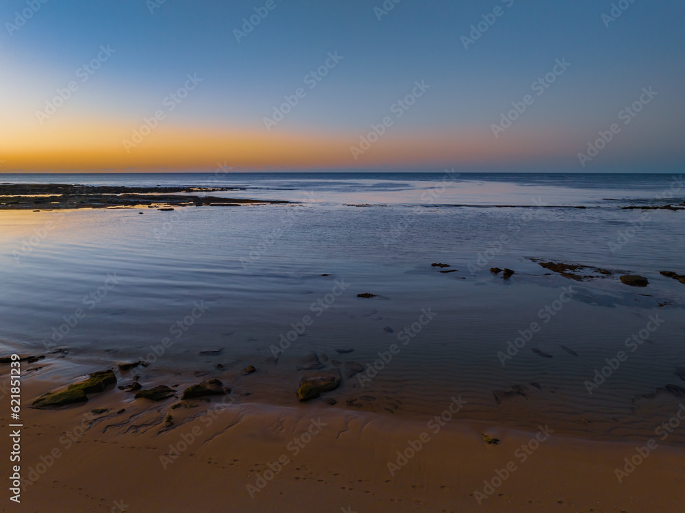 Sunrise with clear skies and calm seas