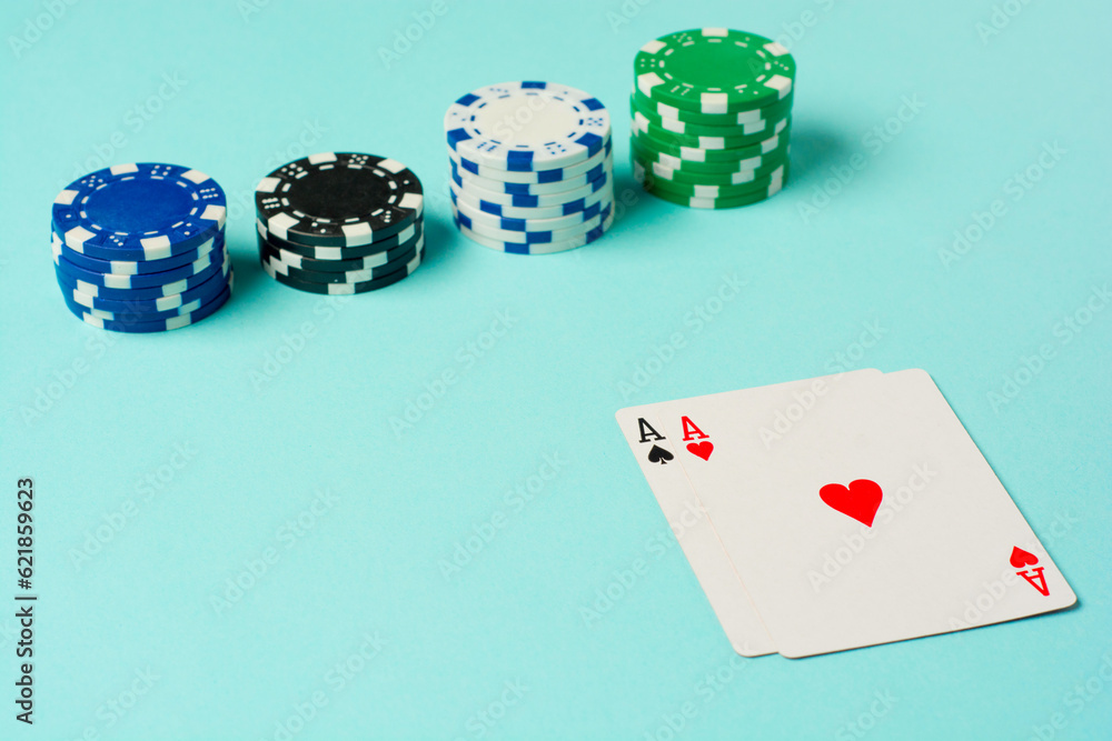 Poker chips and playing cards on colorful background Poker chips and playing cards on colorful background