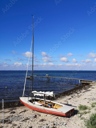 Small sailboat berthed at the beach of Sonderby, Kegnaes