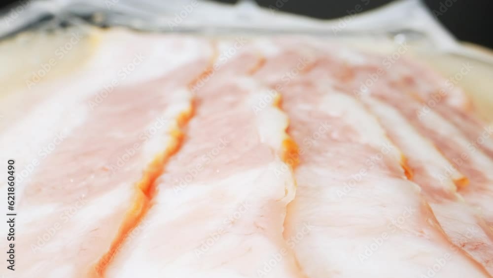 With a probe lens, this macro video showcases the raw bacon's uncooked beauty. Each delicate fiber and delicate fatty strand are highlighted. Processed food concept. Bacon background. 4K HDR
With a probe lens, this macro video showcases the raw bacon's uncooked beauty. Each delicate fiber and delicate fatty strand are highlighted. Processed food concept. Bacon background. 4K HDR