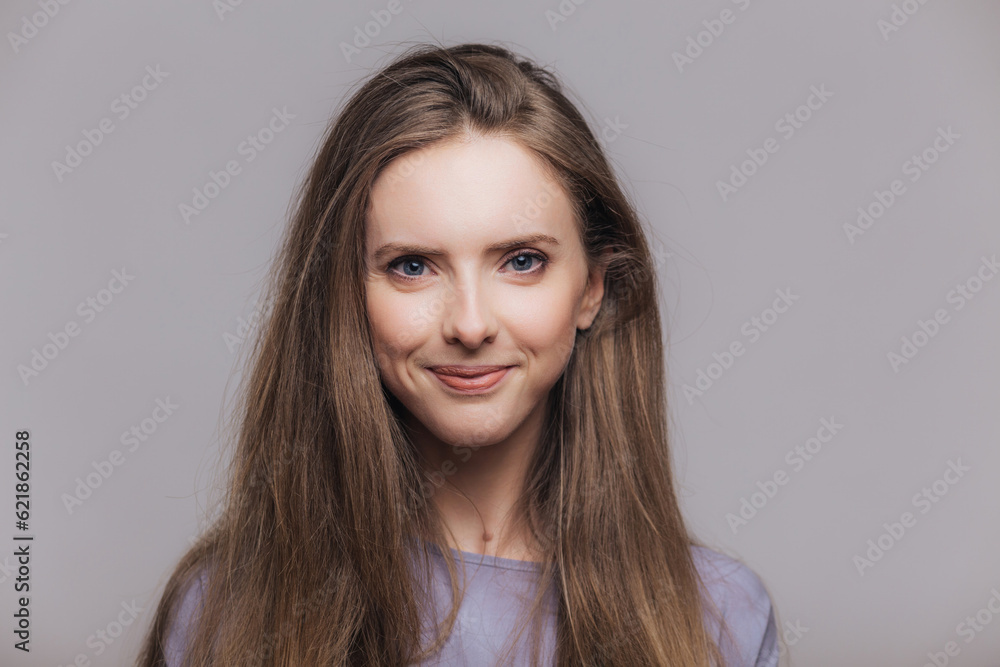 Content brunette model with blue eyes, isolated on grey. Studio shot of delighted woman. Content brunette model with blue eyes, isolated on grey. Studio shot of delighted woman.
