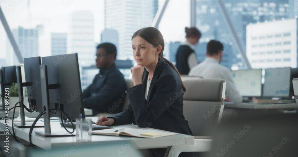 Focused Female Operations Specialist Typing On Desktop Computer In Diverse Corporate Office With Megapolis Window View. Professional Caucasian Woman Writing Emails to Clients, Scheduling Meetings. Focused Female Operations Specialist Typing On Desktop Computer In Diverse Corporate Office With Megapolis Window View. Professional Caucasian Woman Writing Emails to Clients, Scheduling Meetings.