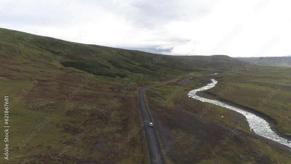 Toyota SUV on a gravel road, next to a wild river, Lundur, drone shot, Iceland, Europe Toyota SUV on a gravel road, next to a wild river, Lundur, drone shot, Iceland, Europe