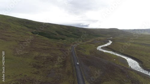 Toyota SUV on a gravel road, next to a wild river, Lundur, drone shot, Iceland, Europe photo