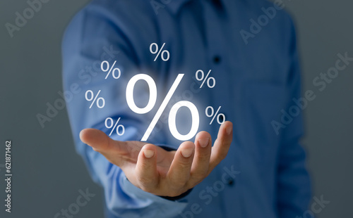 Concept of financial interest rates and dividends provision of financial services.Businessman showing percentage icons and up arrow icons. Interest Rates Stocks Finance Ratings Mortgage Rates..
