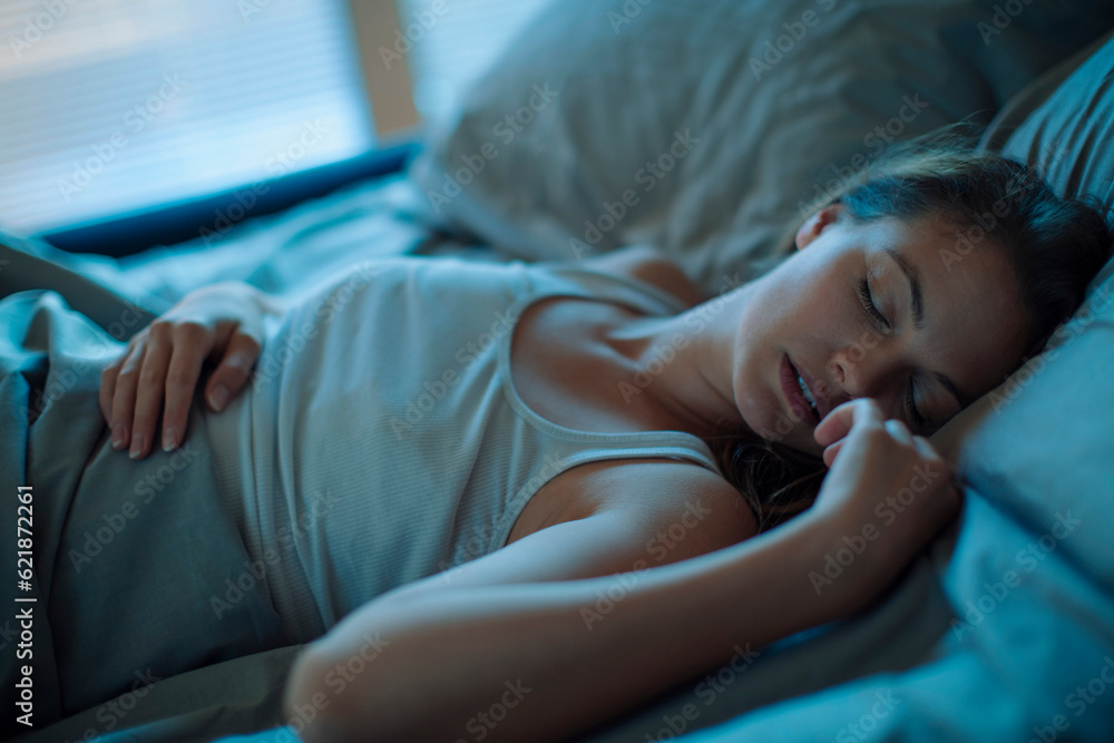 Young woman sleeping in her bed in the bedroom Young woman sleeping in her bed in the bedroom