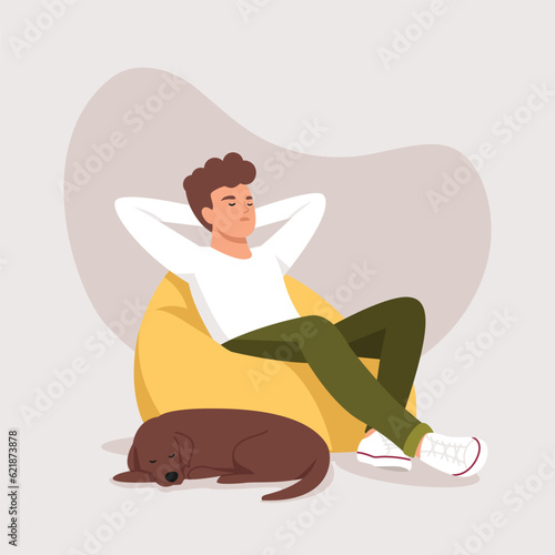 a man sleeps (rests) in a bean bag chair with dog