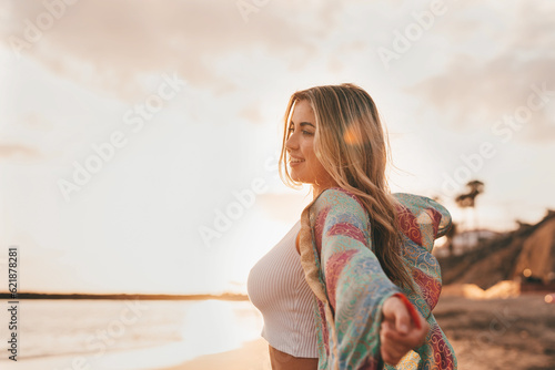 Portrait of one young woman at the beach looking at the sea enjoying free time and freedom outdoors. Having fun relaxing and living happy moments.. #621878281