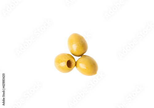 Delicious green olives isolated on white background. Olive and olive tree branches on a white table. Delicacy.