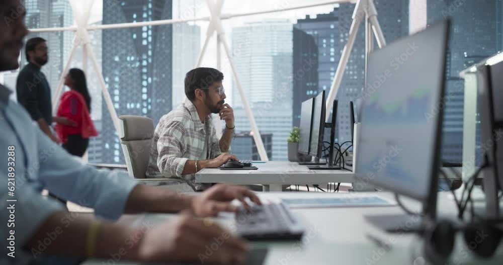 Team of Talented Young Indian Professionals Working in a Corporate Banking Agency. Financial Analysts and Managers Working on Computers in a South Asian Business Office with City View with Skyscrapers