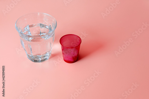 Medicine and health. A glass of water and a drink-a-pill glass.