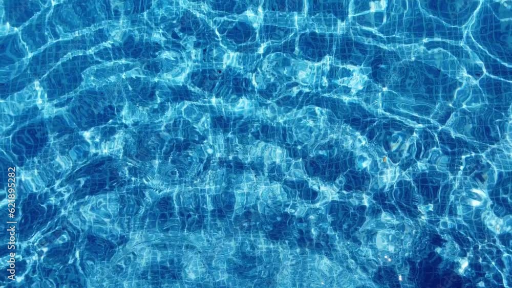 Swimming pool. Upper view of crystal water moving in the pool. Hot summer holidays. Swimming in the pool. Swimming pool. Upper view of crystal water moving in the pool. Hot summer holidays. Swimming in the pool.