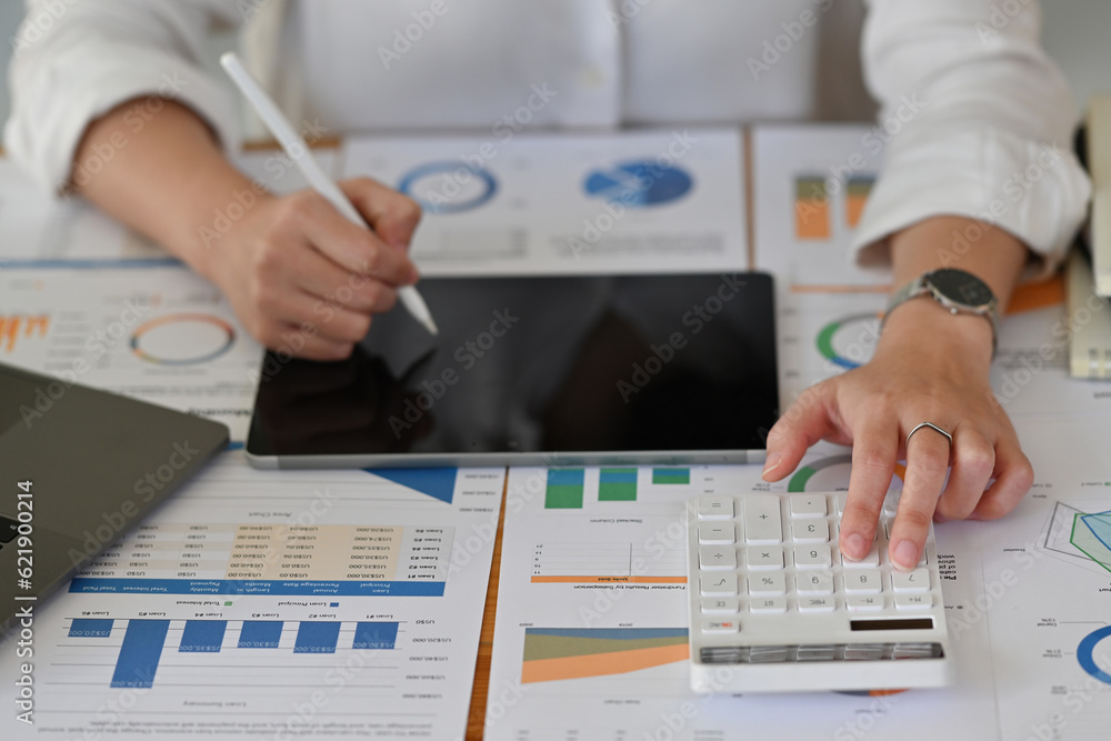 Top view image of Accountant working with laptop and calculator for analyze business data, accountancy document. Top view image of Accountant working with laptop and calculator for analyze business data, accountancy document.