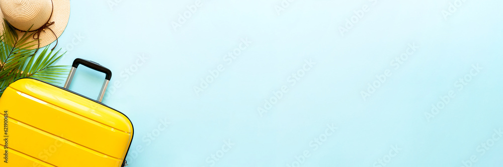 Photography Suitcase, hat and flip flops on blue background.