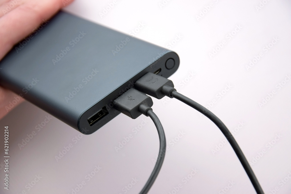 Power bank for charging mobile devices. Black smart phone charger with power bank. Power bank for charging mobile devices. Black smart phone charger with power bank.