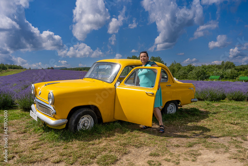 woman with yellow retro car, lavender field 