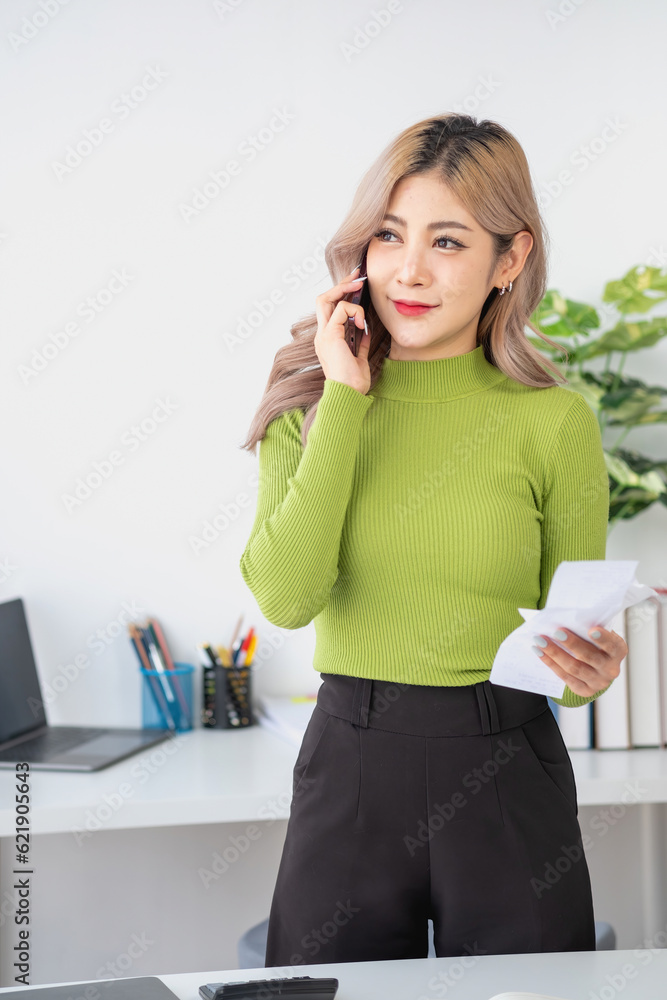 Portrait of a woman business owner showing a happy smiling face as he has successfully invested in her business using tablets and financial budget documents at work. Portrait of a woman business owner showing a happy smiling face as he has successfully invested in her business using tablets and financial budget documents at work.