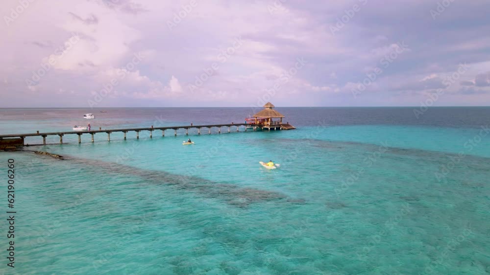 Aerial view of Kayakers on crystal clear blue ocean, Baa Atoll, Maldives. Aerial view of Kayakers on crystal clear blue ocean, Baa Atoll, Maldives.