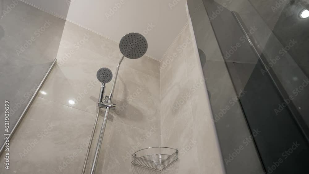 Close up modern glass shower in white ceramic bathroom. Luxury hotel