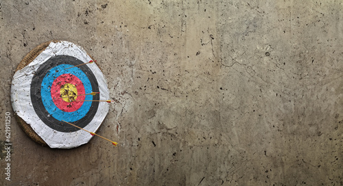 Archery target on the concrete wall background.