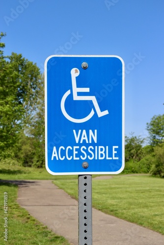 A close view of the blue handicap sign.