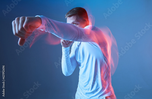 Left kick. Boxer in white rashguard on blue background. 