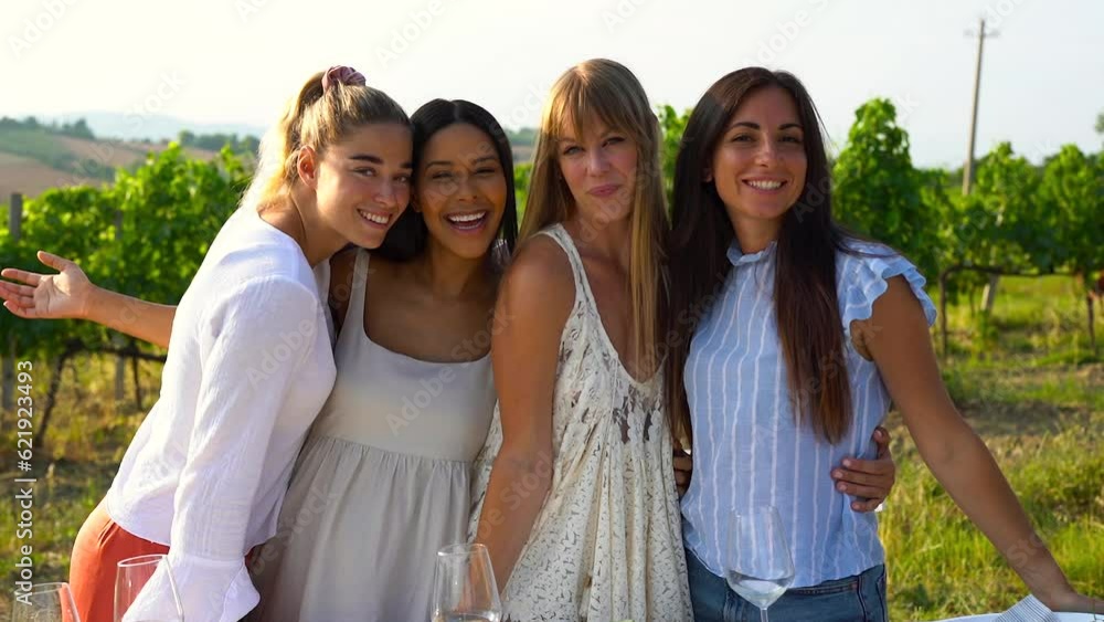 Young multiracial women smiling on camera with wineyard in background during summer time - Friendship concept
Young multiracial women smiling on camera with wineyard in background during summer time - Friendship concept