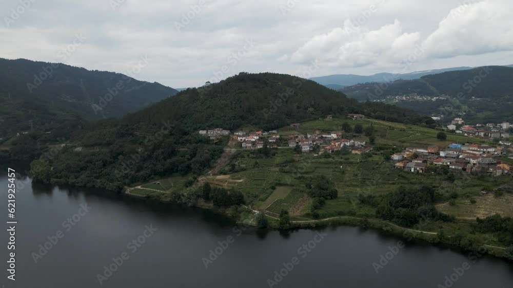 Aerial view of a small village along the Minho river in Val de Pereira, Ourense, Spain. Aerial view of a small village along the Minho river in Val de Pereira, Ourense, Spain.