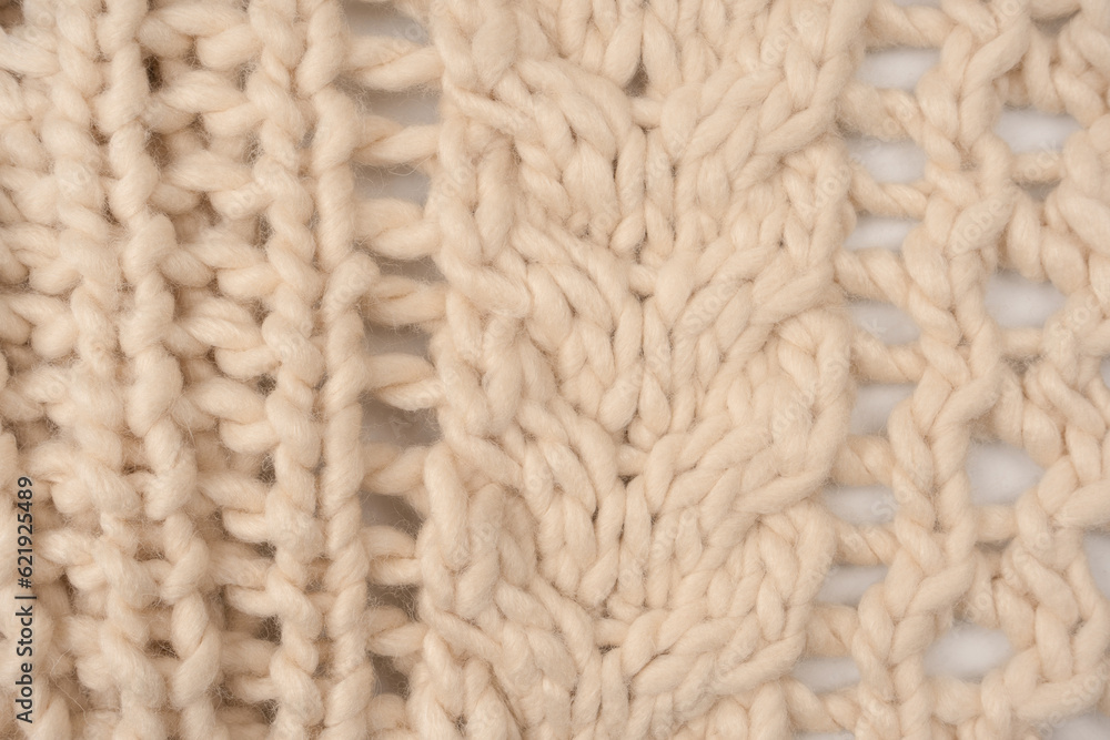 A fragment of beige knitted fabric, knitted from white sheep wool. A fragment of beige knitted fabric, knitted from white sheep wool.