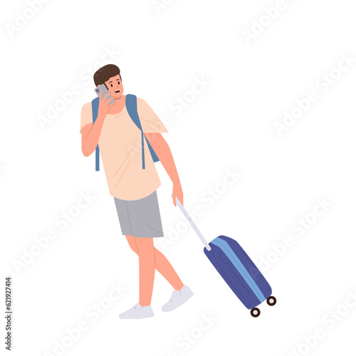 Worried young man traveler carrying luggage bag talking by mobile phone isolated on white background