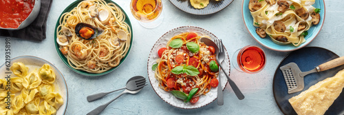 Pasta variety panorama. Italian food and drinks, overhead flat lay shot. Spaghetti marinara, mushroom pappardelle, seafood pasta, wine etc