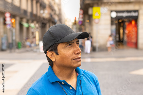 Close-up portrait of a smiling Peruvian man in the city.