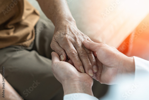 Parkinson disease patient, Alzheimer elderly senior, Arthritis person's hand in support of geriatric doctor or nursing caregiver, for disability awareness day, ageing society care service photo