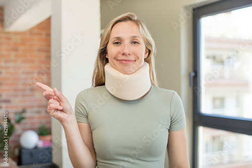 smiling cheerfully, feeling happy and pointing to the side. accident collar concept photo