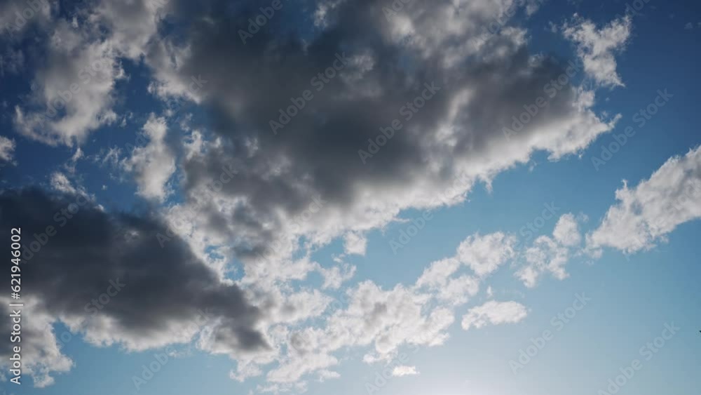 TimeLapse of beautiful blue sky with bright sun light shining through white clouds TimeLapse of beautiful blue sky with bright sun light shining through white clouds