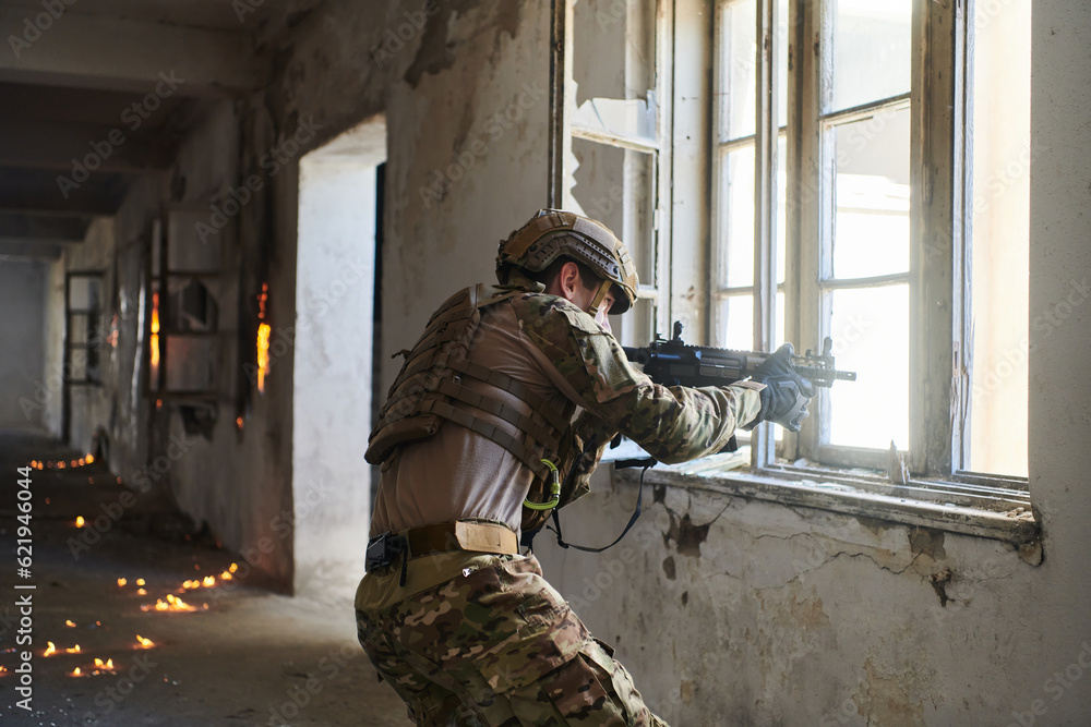 Fototapeta premium A professional soldier carries out a dangerous military mission in an abandoned building