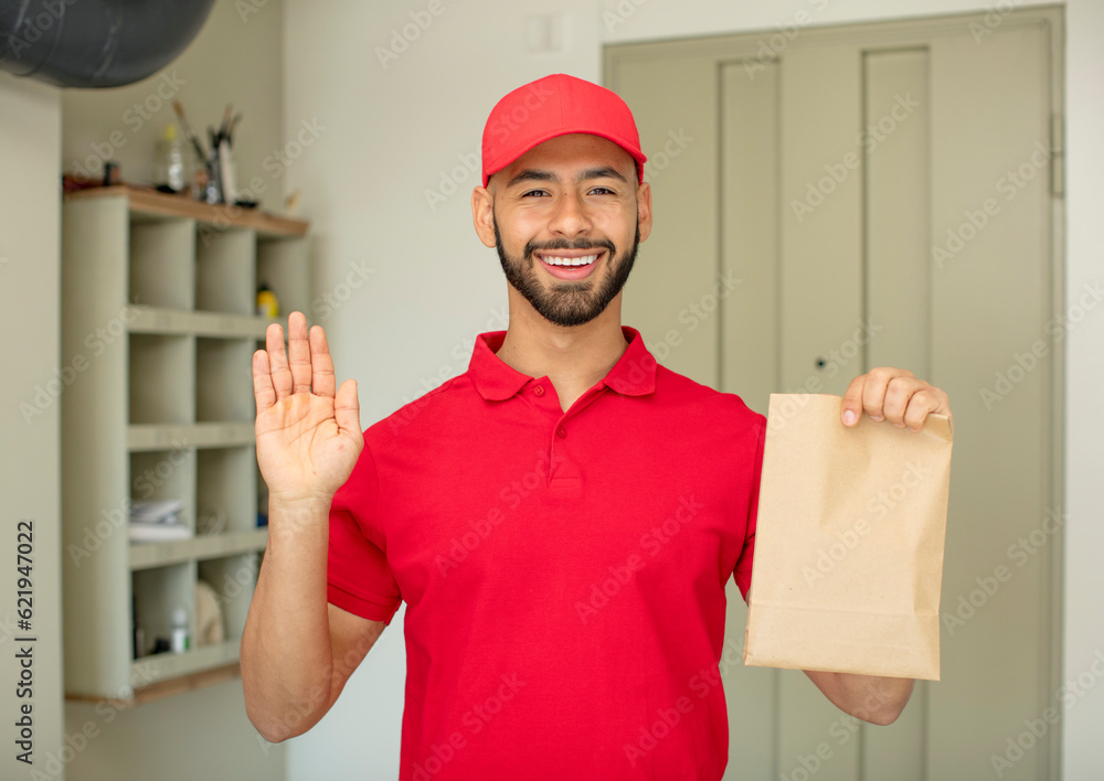 young adult man feeling happy and astonished at something unbelievable. deliveryman concept young adult man feeling happy and astonished at something unbelievable. deliveryman concept