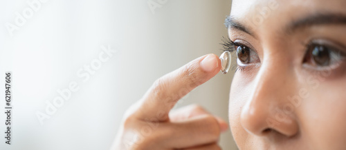 Optimise vision by contact lens, Close-up of woman face during insert contact lens to her eyes.