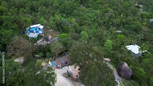 Aerial view of a vehicle driving a forest road on the hill in Tanote bay on the east coast of Thailand. photo