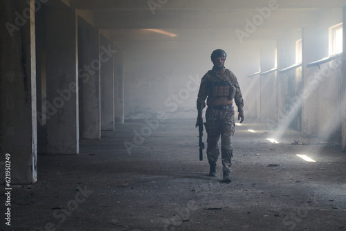 A professional soldier in an abandoned building shows courage and determination in a war campaign © .shock
