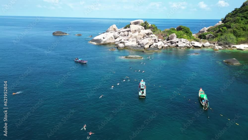 Aerial view of person snorkeling and swimming in transparent sea on Sairee beach on Ko Tao island, Thailand. Aerial view of person snorkeling and swimming in transparent sea on Sairee beach on Ko Tao island, Thailand.