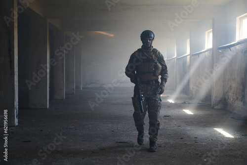 A professional soldier in an abandoned building shows courage and determination in a war campaign