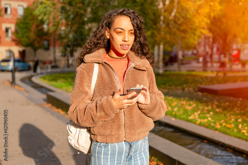 Outdoor portrait of an woman using a mobile phone visiting a Europe city