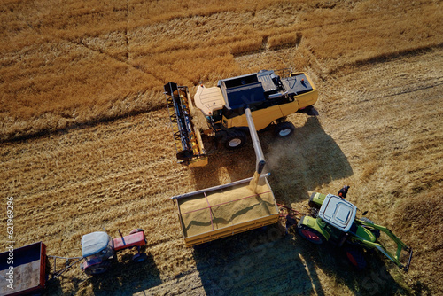 Harvesting machine working at agricultural field. Combine harvester collecting golden wheat field. Harvest reaping season © Lazy_Bear