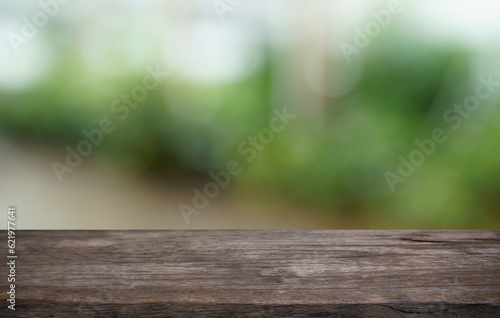 Empty wood table top and blur of out door garden background Empty wooden table space for text marketing promotion. blank wood table copy space for background